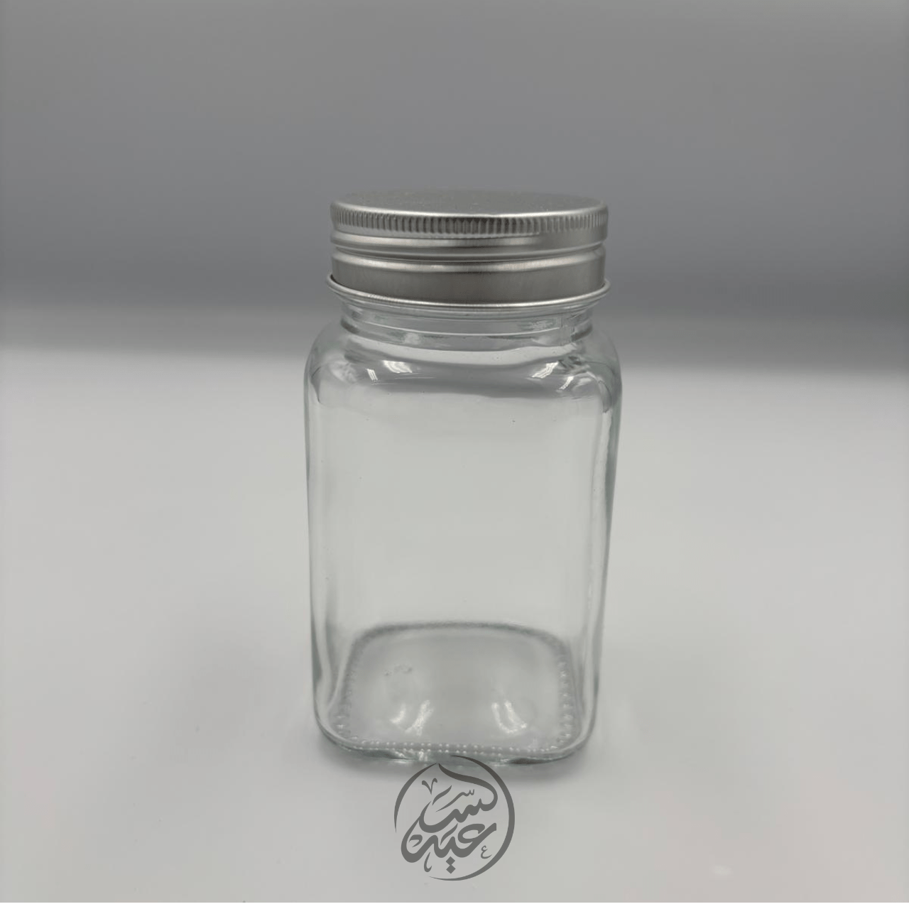 Glass container with a metal lid علبة زجاجية مع غطاء معدني - بهارات و عطارة السعيد