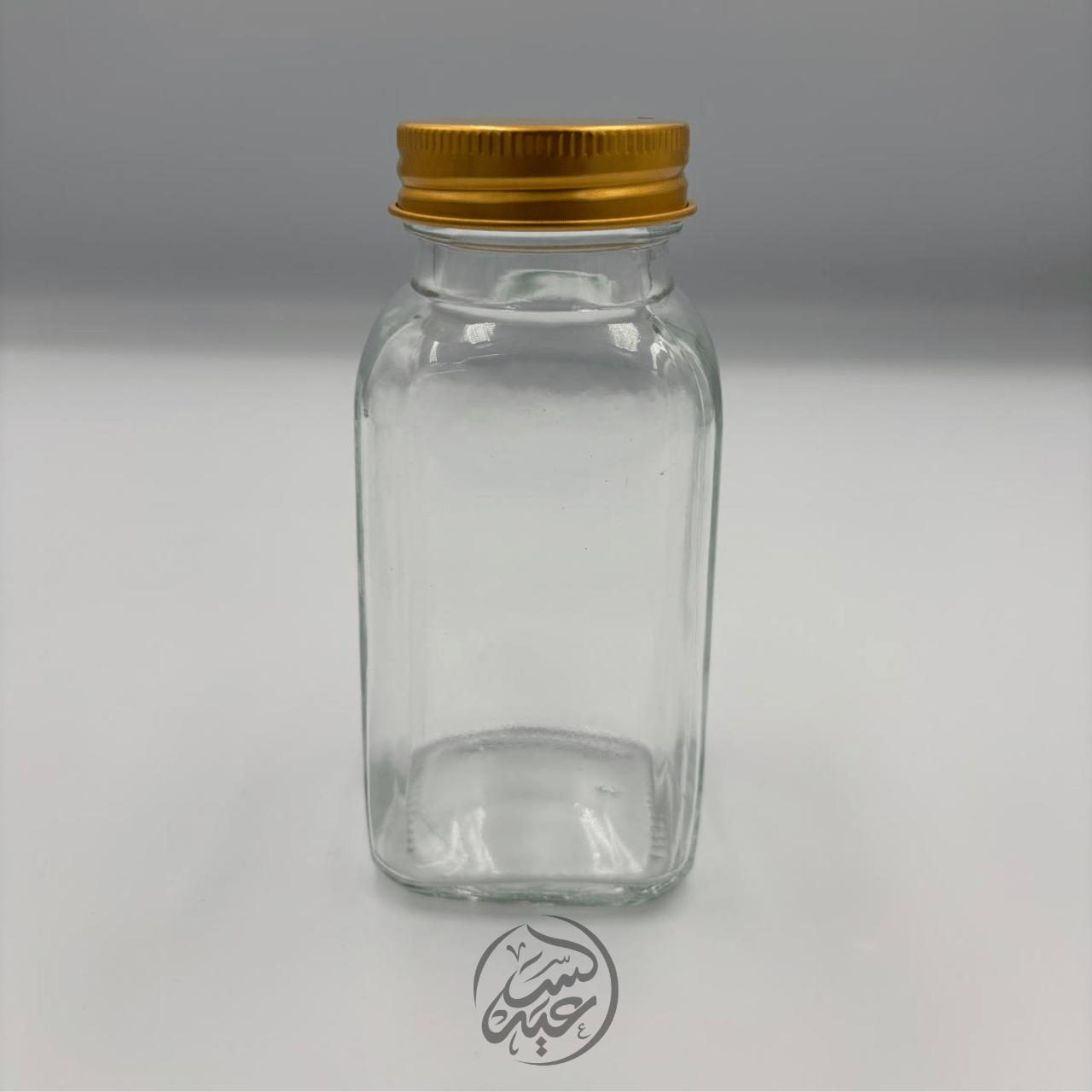 Glass container with a metal lid علبة زجاجية مع غطاء معدني - بهارات و عطارة السعيد