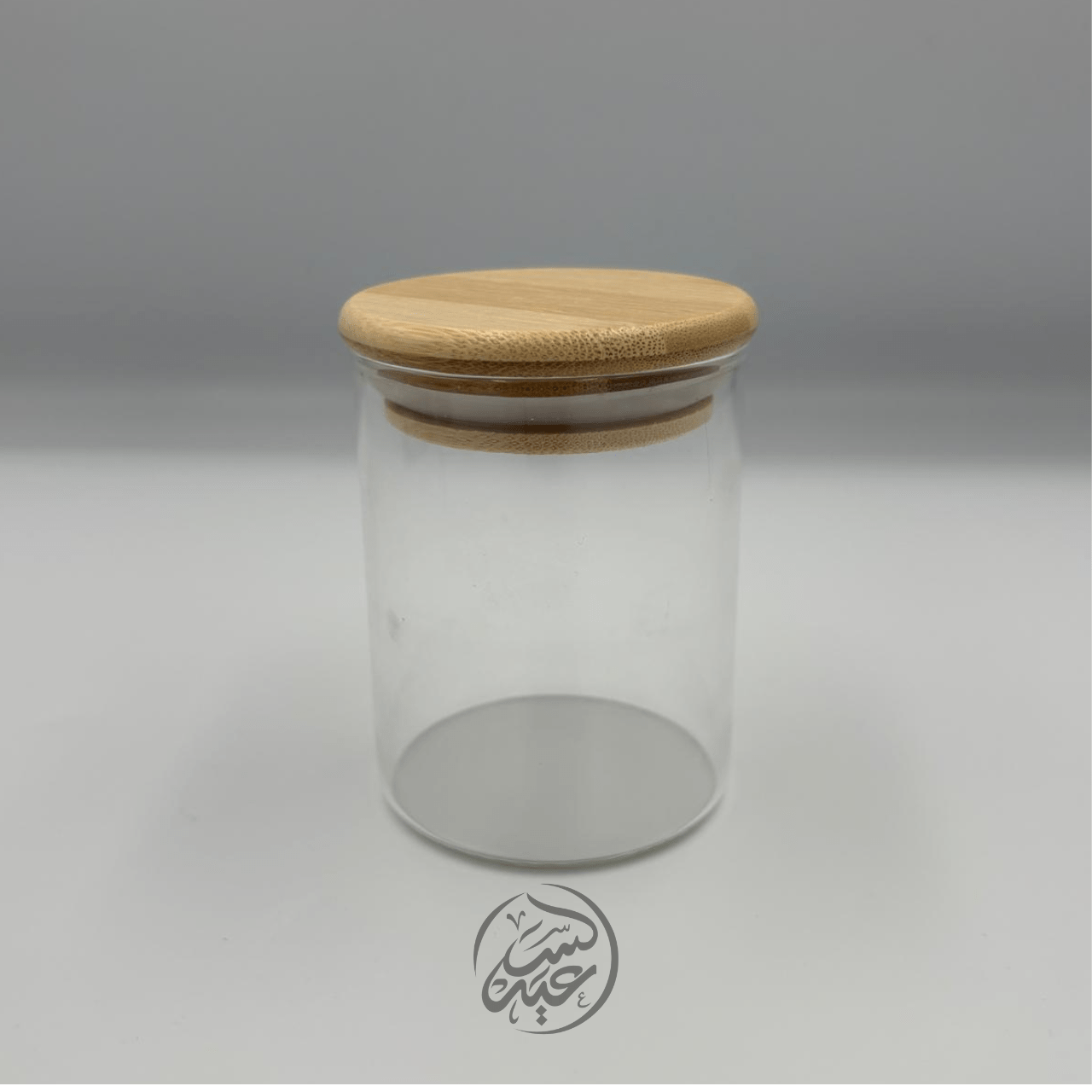 Glass container with a wooden lid علبة زجاجية مع غطاء خشبي - بهارات و عطارة السعيد