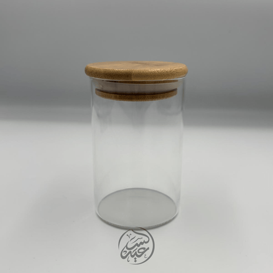 Glass container with a wooden lid علبة زجاجية مع غطاء خشبي - بهارات و عطارة السعيد